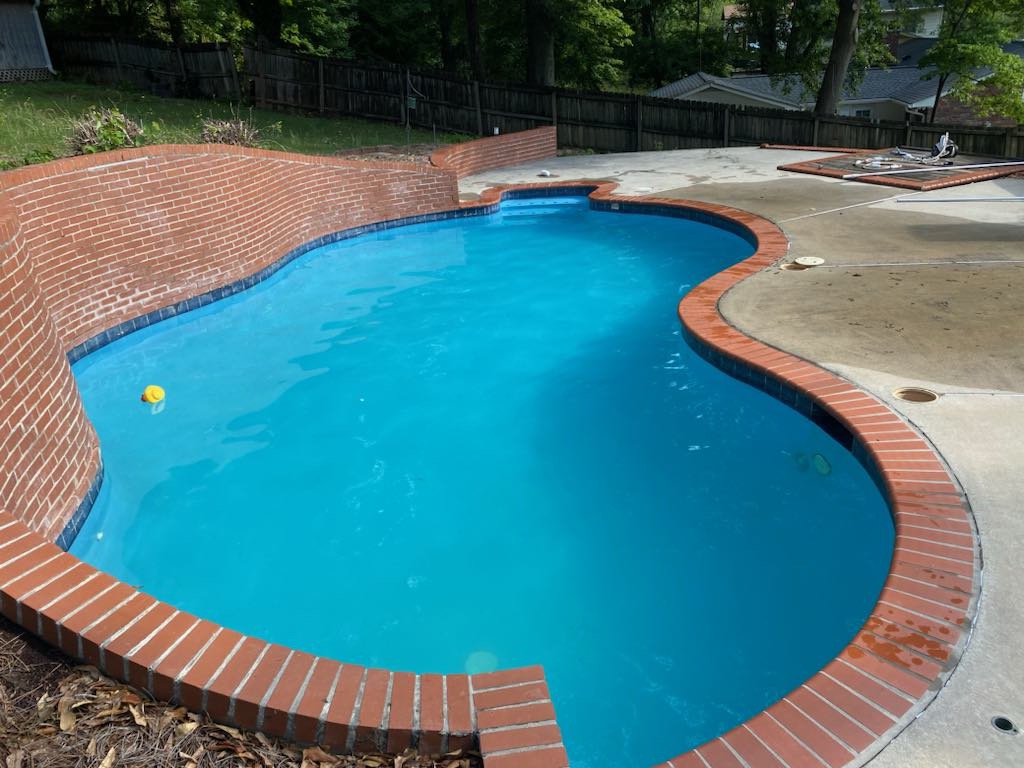 A clean swimming pool with turquoise blue water.